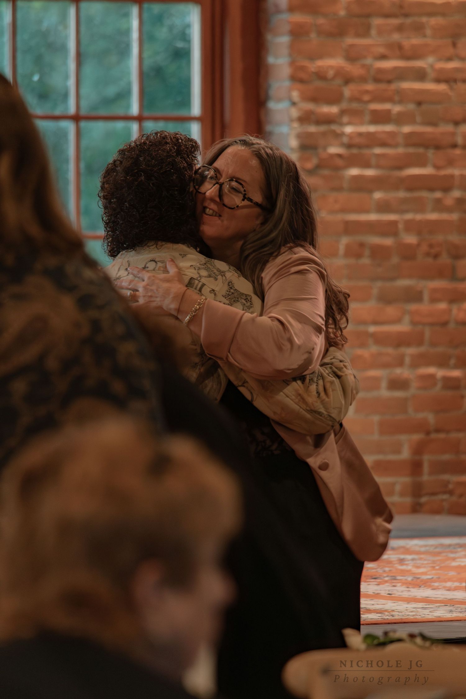 Event photo of guests celebrating in Hudson Valley venue, candid & inclusive. Captured by Nichole JG Photography.