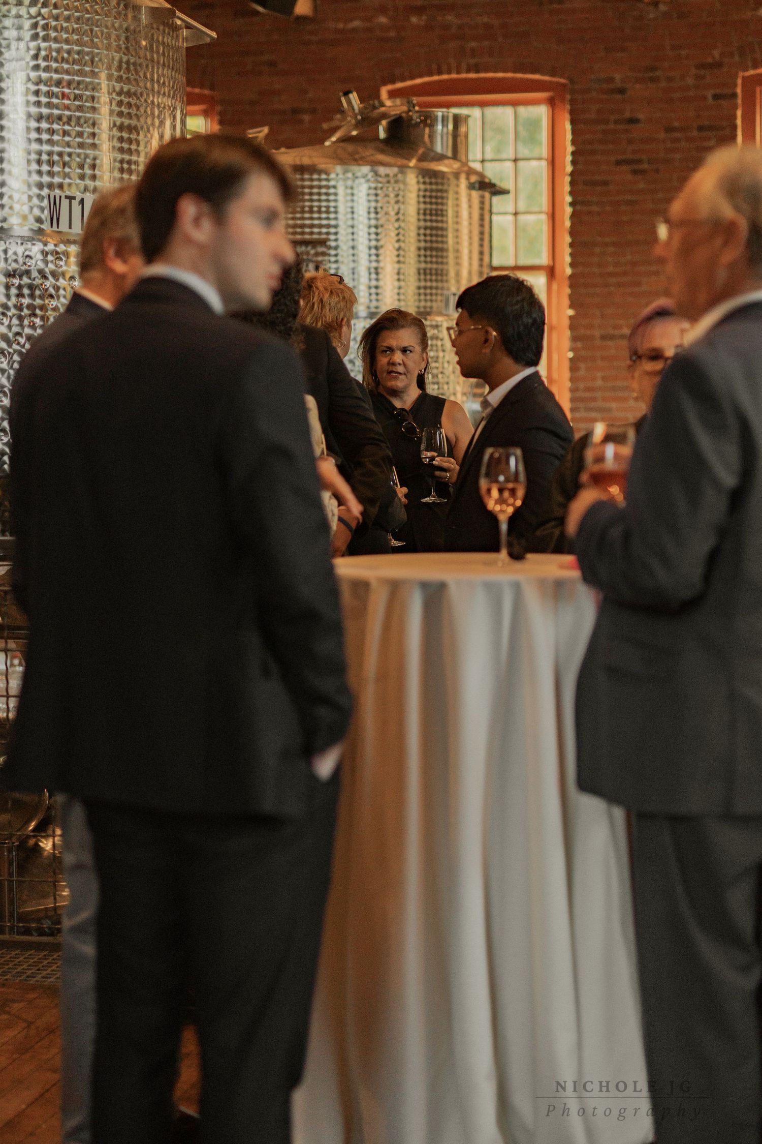Event photo of guests celebrating in Hudson Valley venue, candid & inclusive. Captured by Nichole JG Photography.