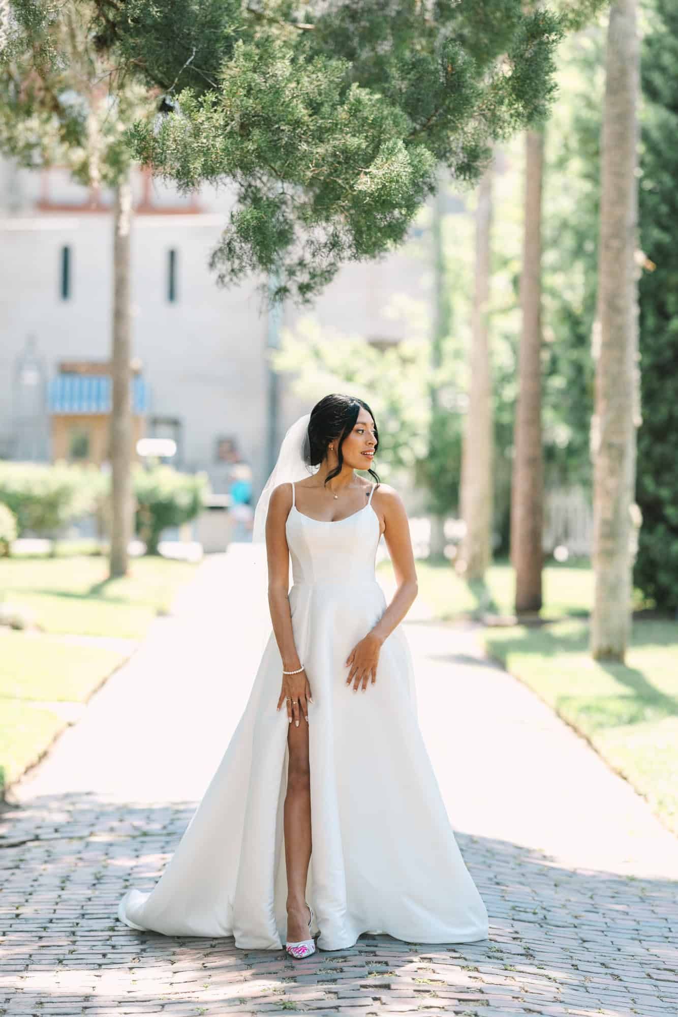 bride standing on cobblestone looking to the right