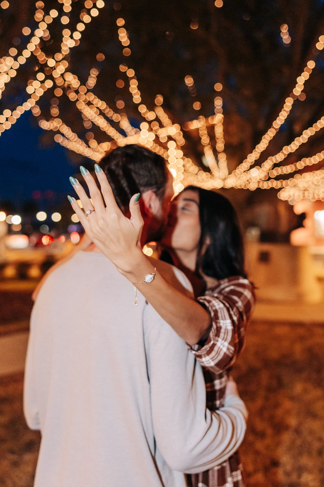 woman showing off her engagement ring at night of lights in st augustine fl