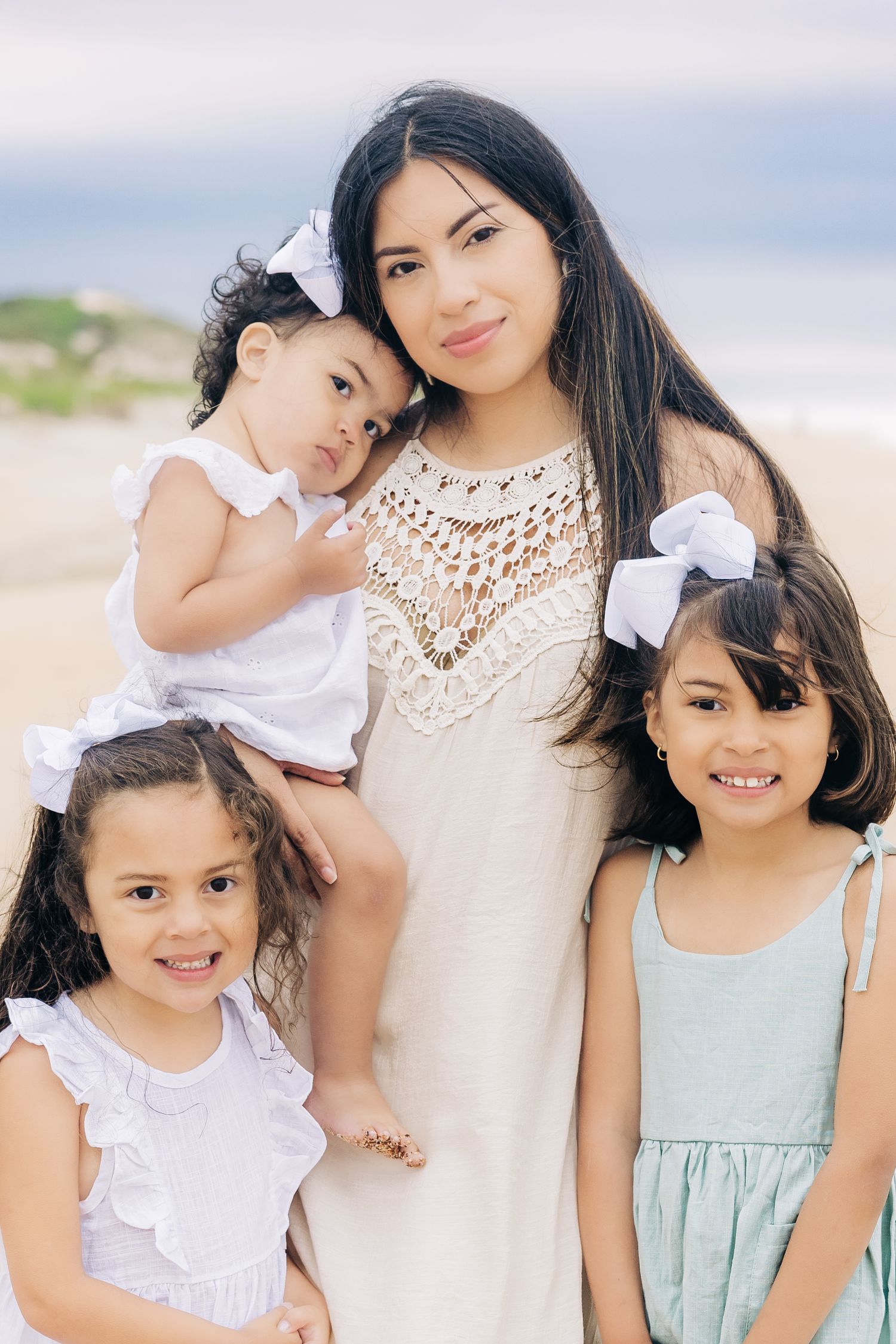 mom smiling with three daughters