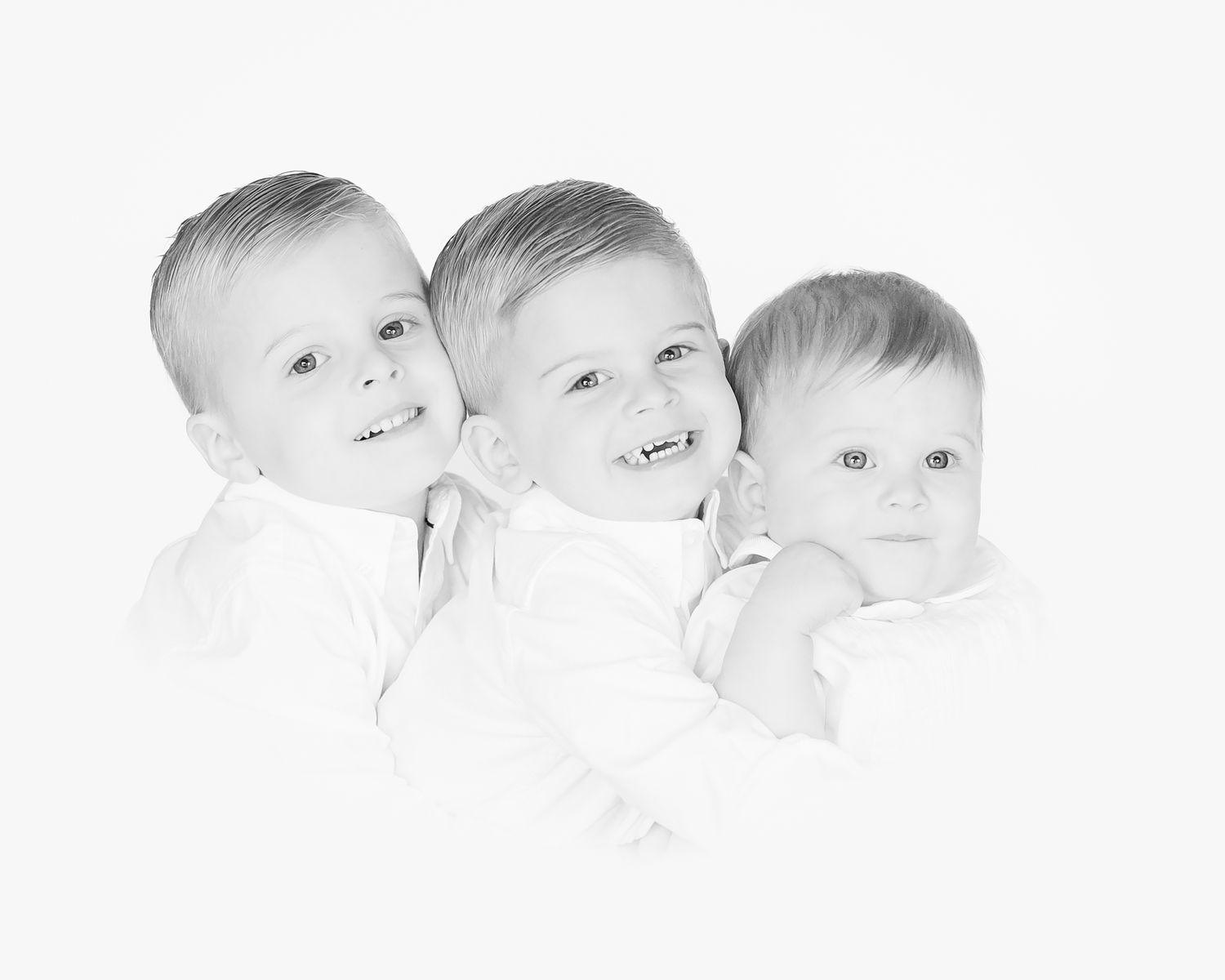 heirloom portrait in black and white of three brothers snuggling