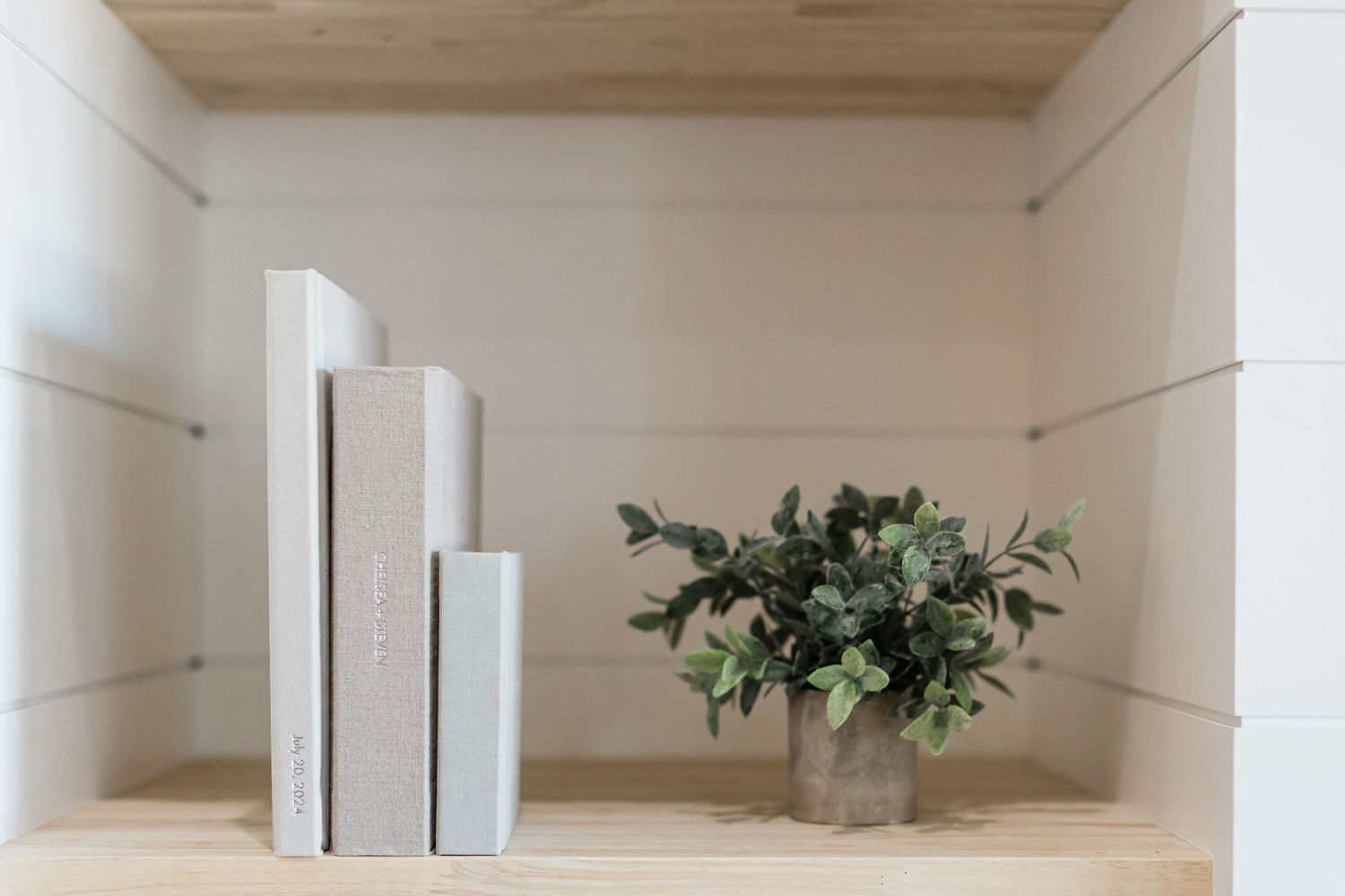 three albums standing on a bookshelf