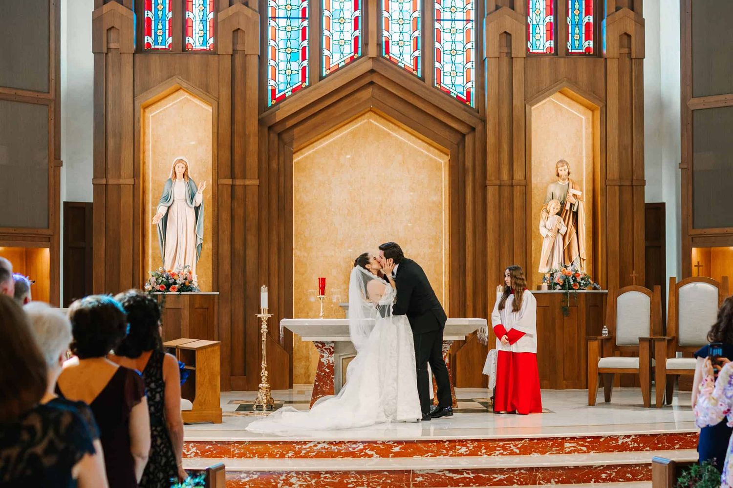 bride and groom first kiss in church ceremony