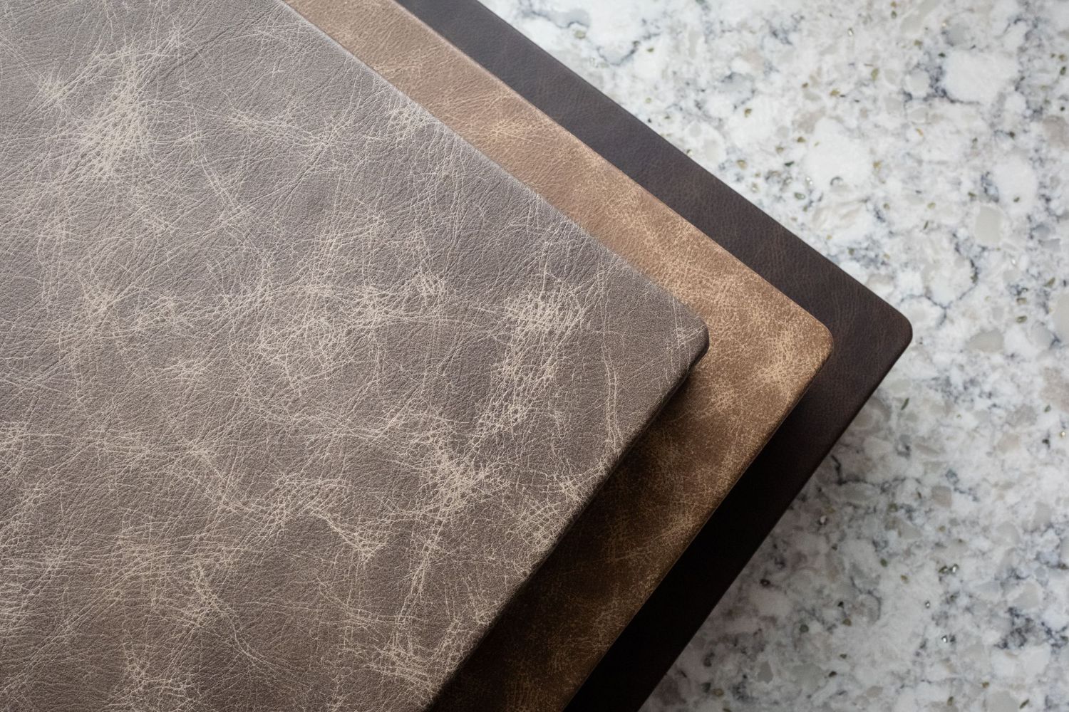 three leather albums stacked