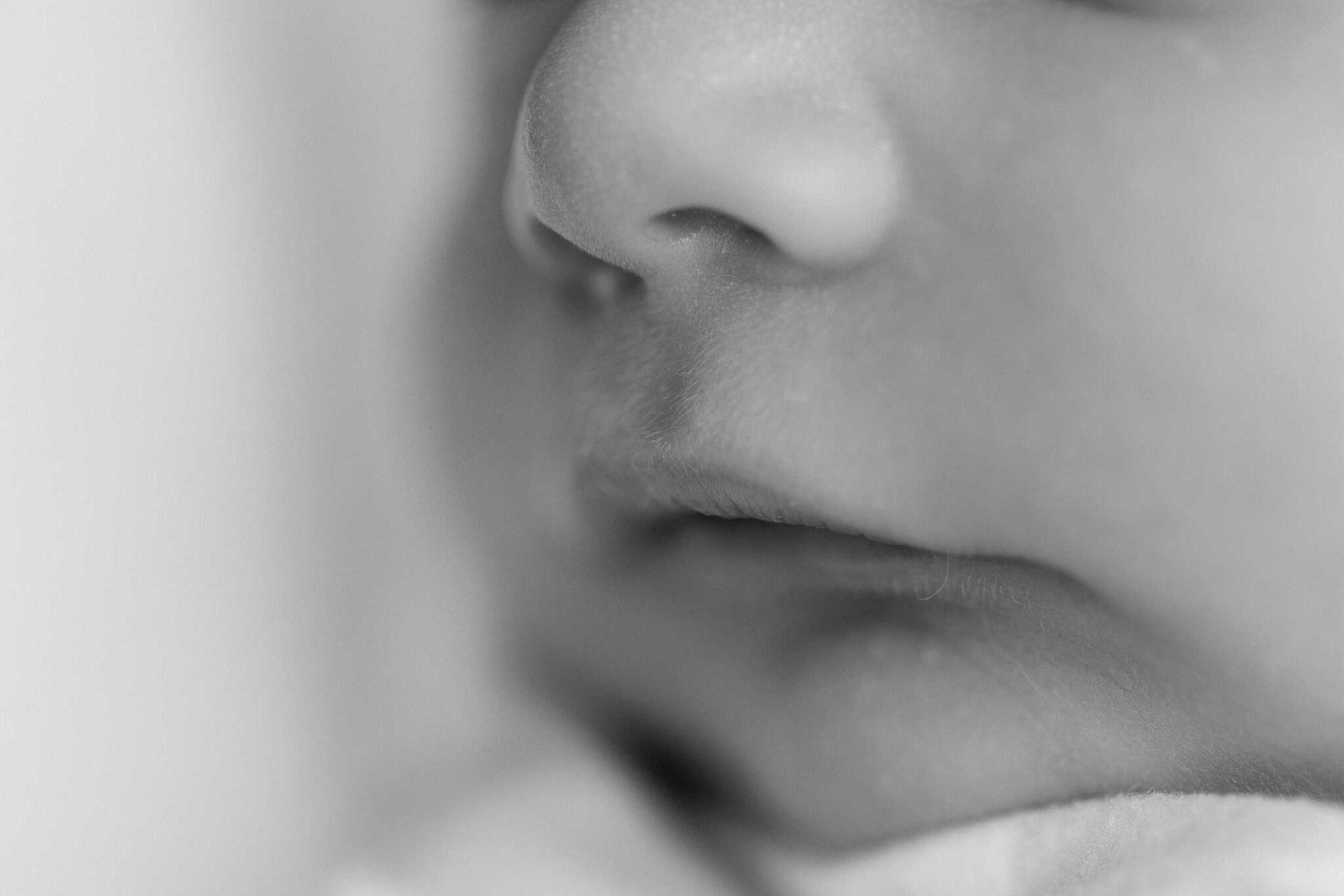 close up of newborn baby nose and lips in black and white