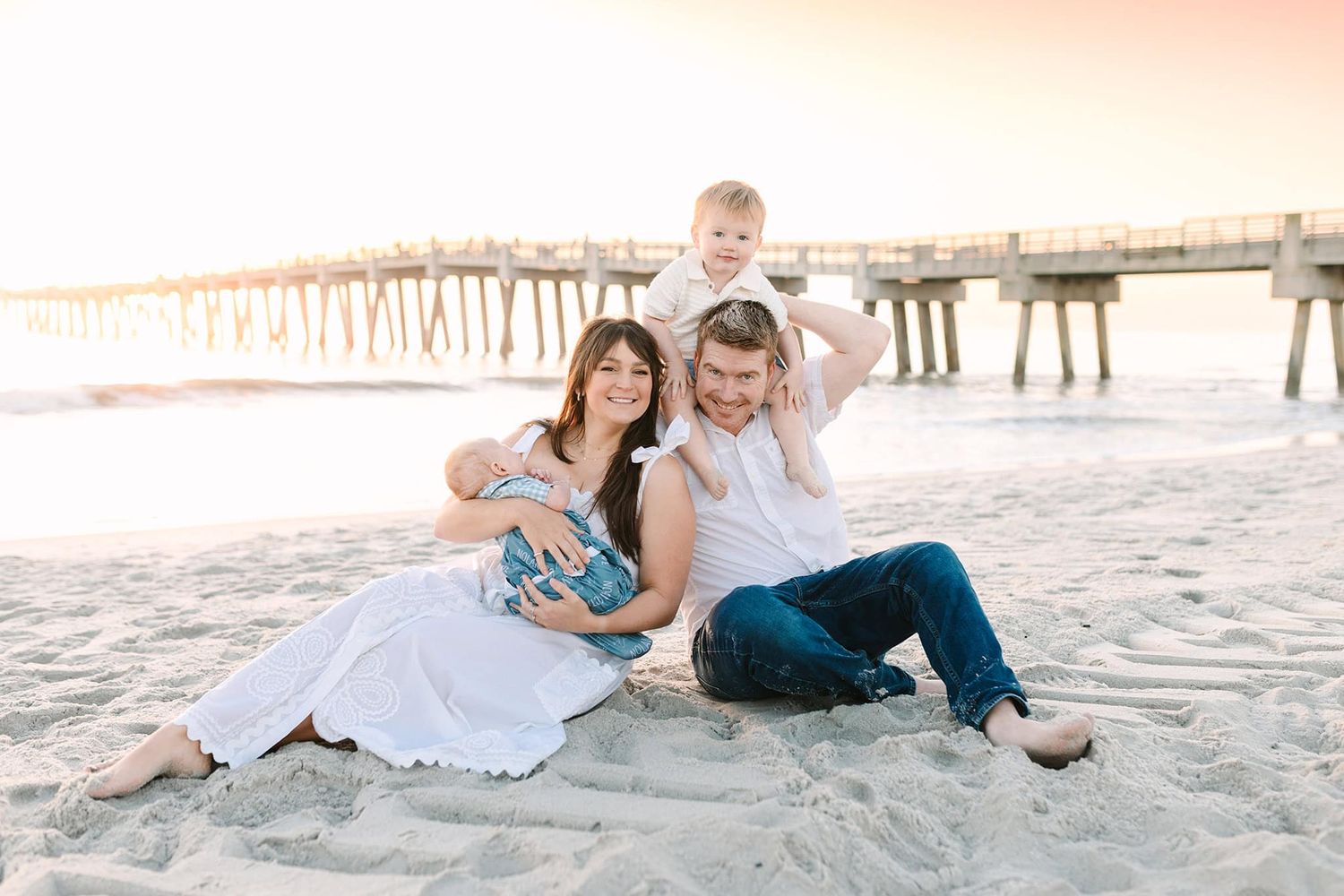 Caitlin Mae sitting on Jacksonville beach with her family at sunrise