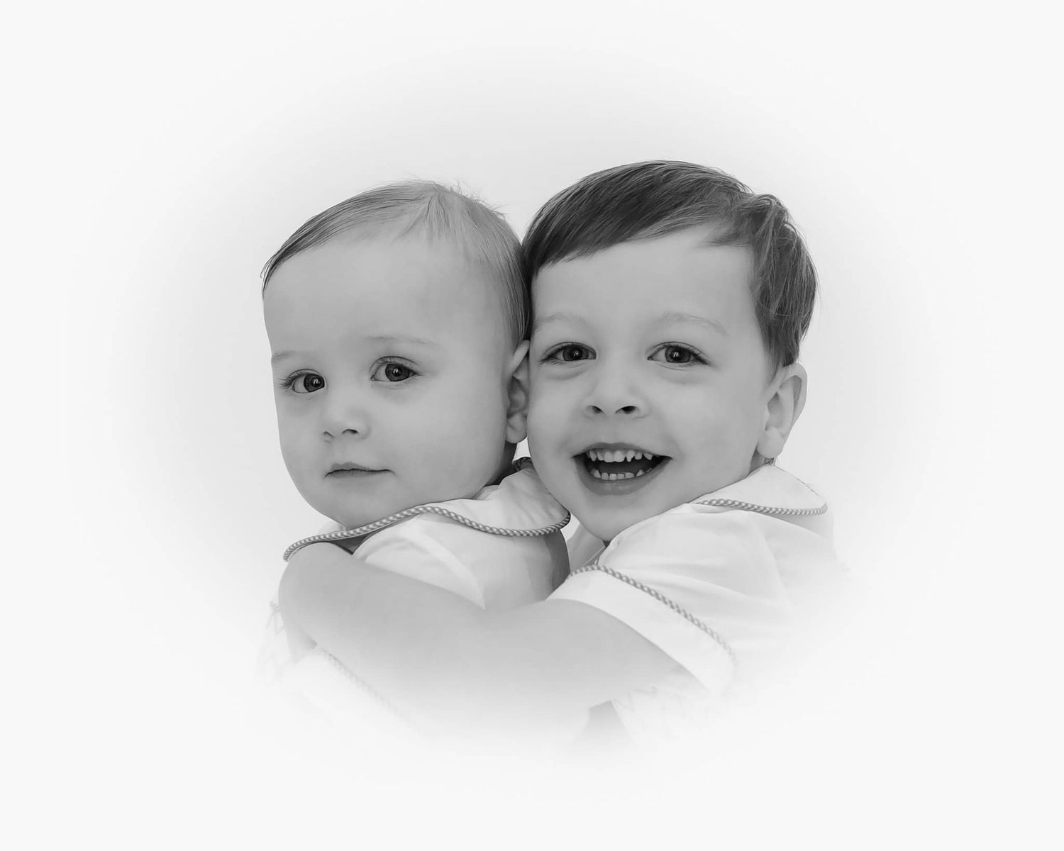 heirloom portrait in black and white of brothers. older brother is hugging little brother