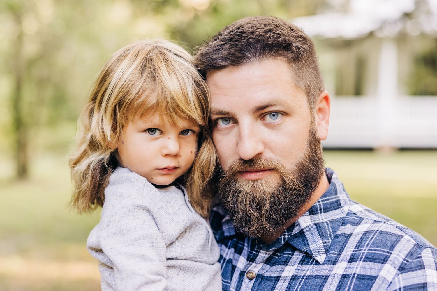 father and son looking right at the camera