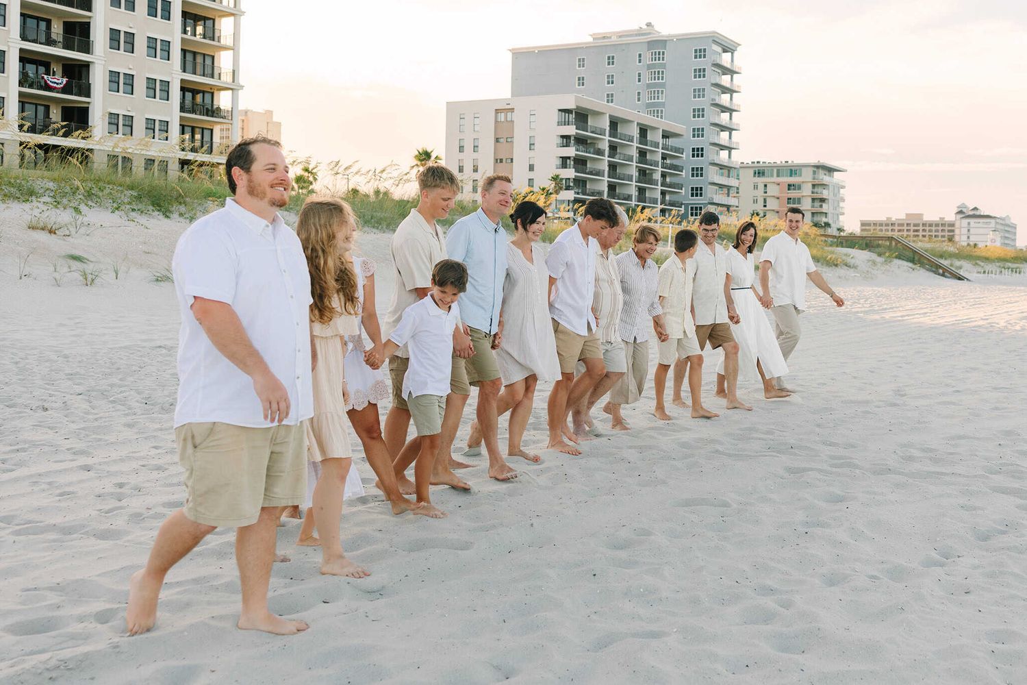 large extended family going for a walk down the beach together