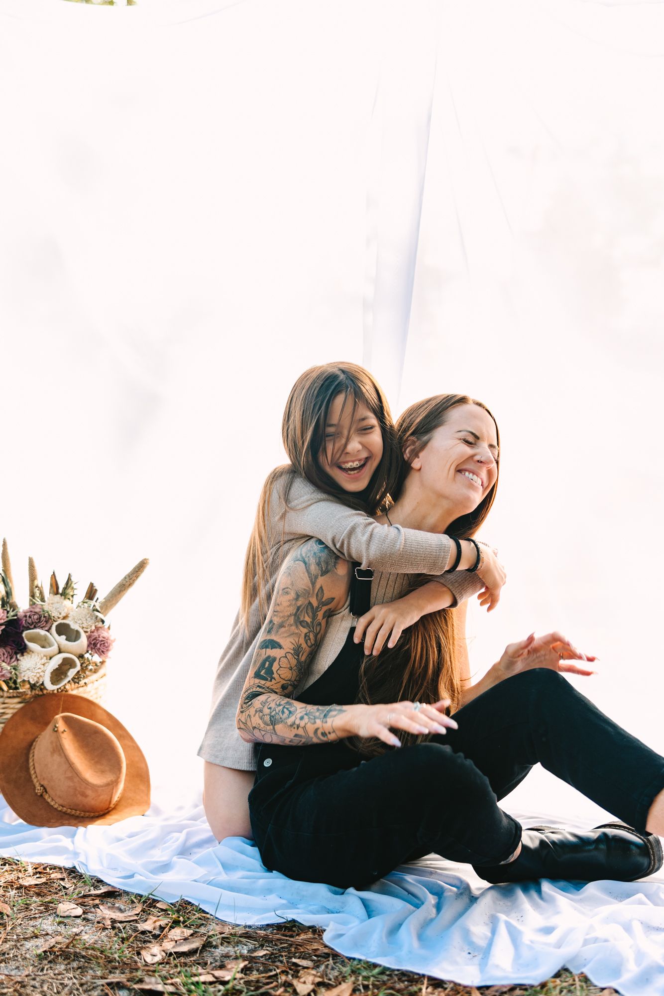 mom and daughter laughing and hugging