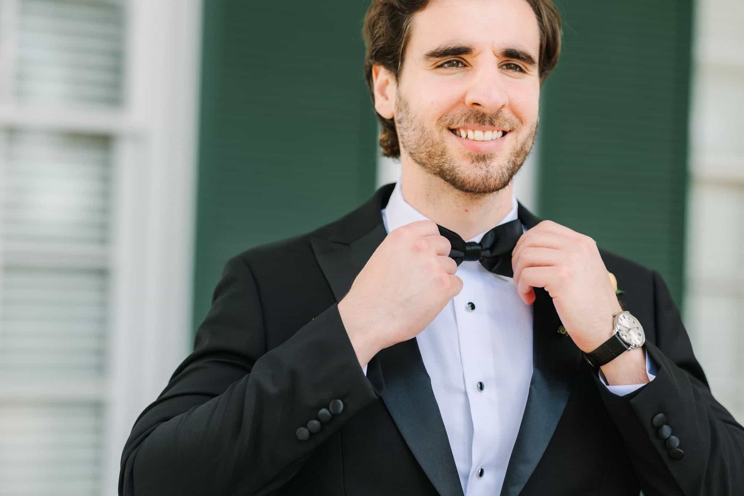 groom fixing his bowtie