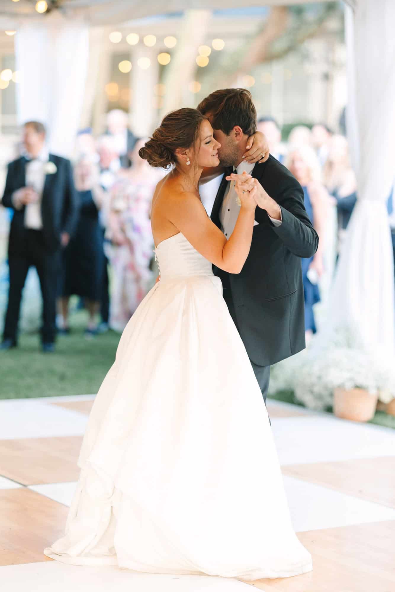 bride hugging groom during first dance