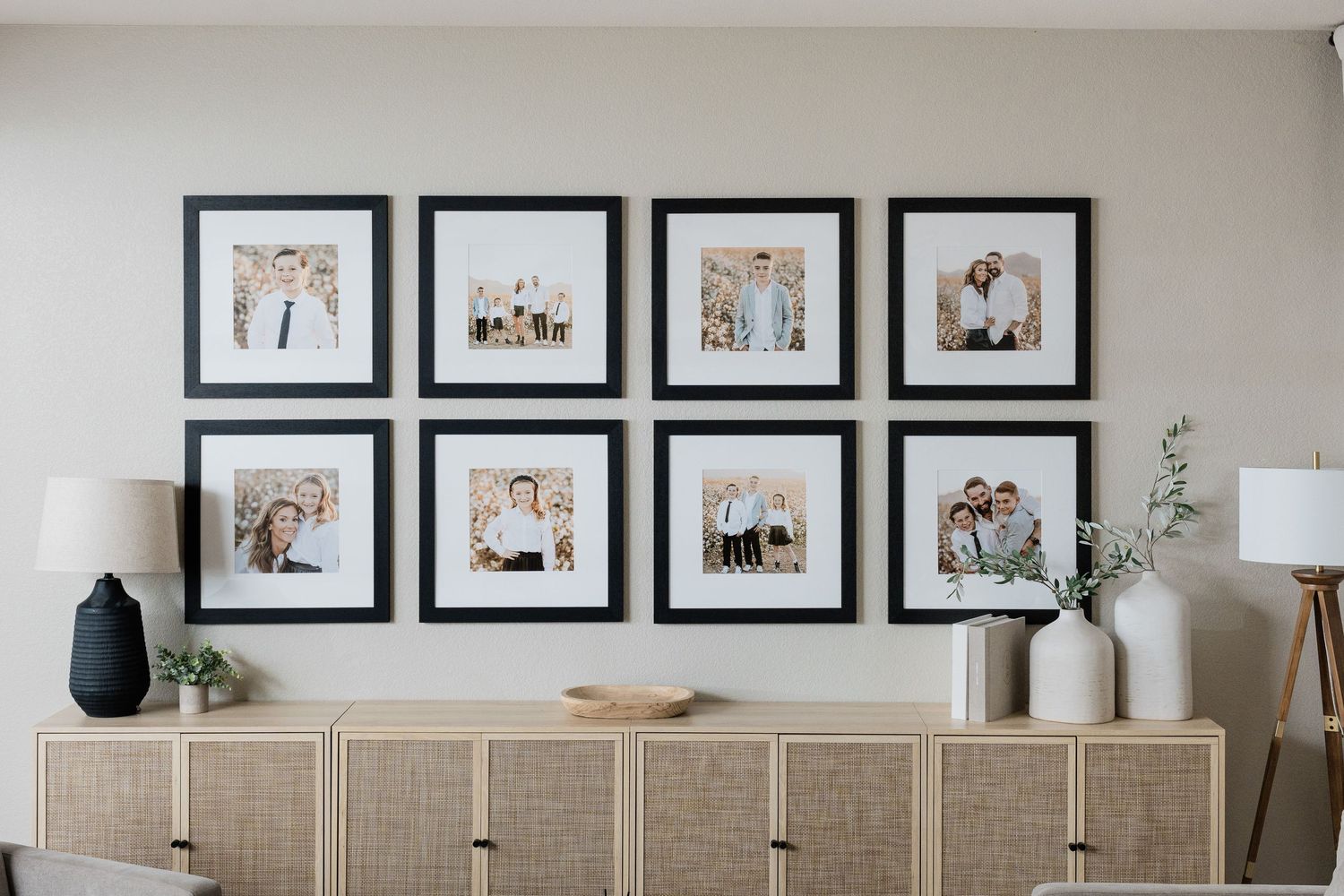 gallery wall of family photographs with black frames over console table taken by a Jacksonville fl photographer