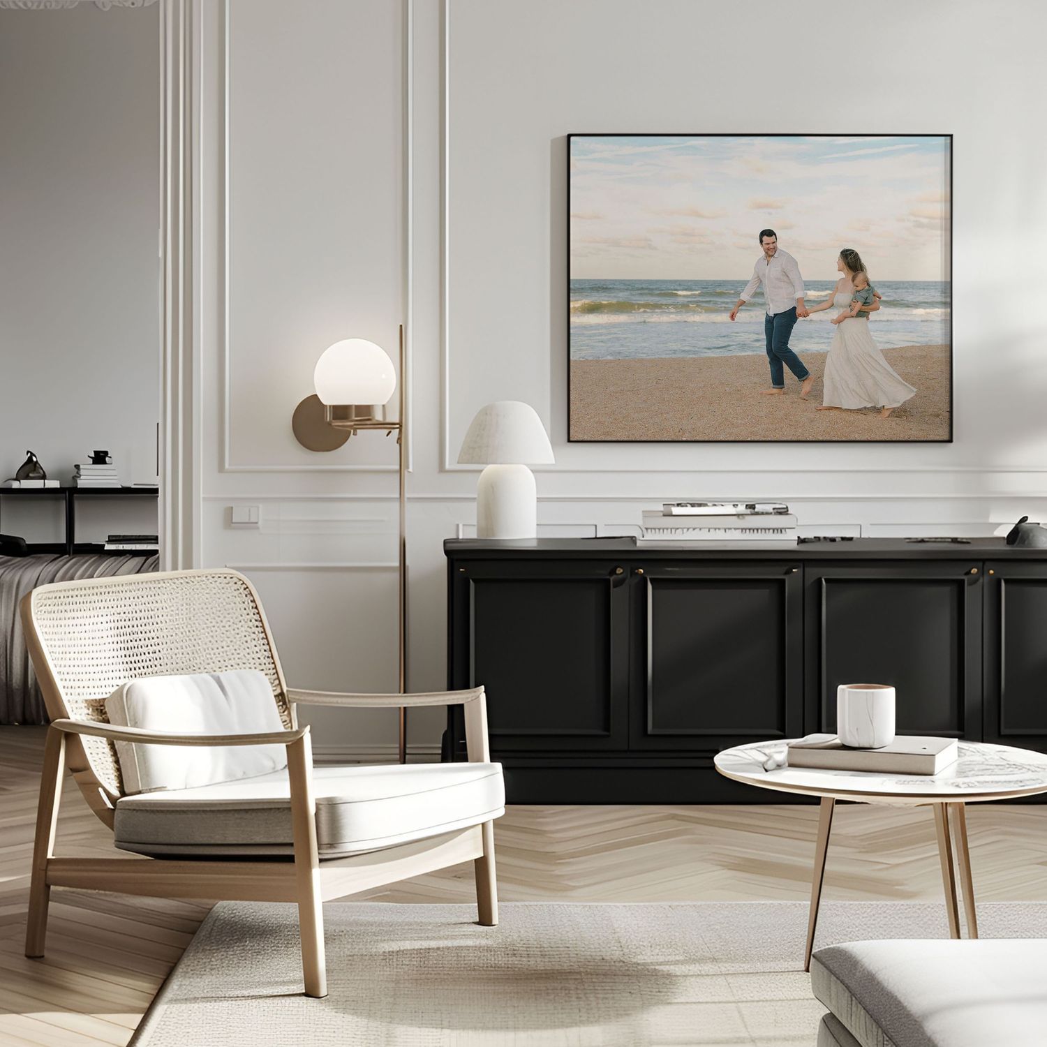 framed photo in living area of mom dad and son walking down the beach