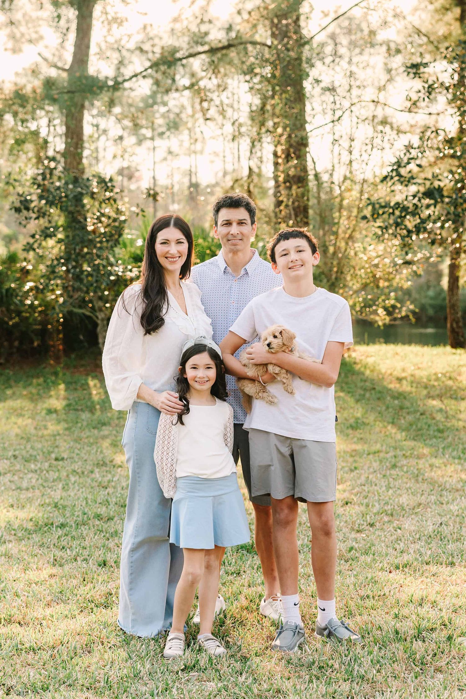 mom, dad, two kids and new puppy in the park