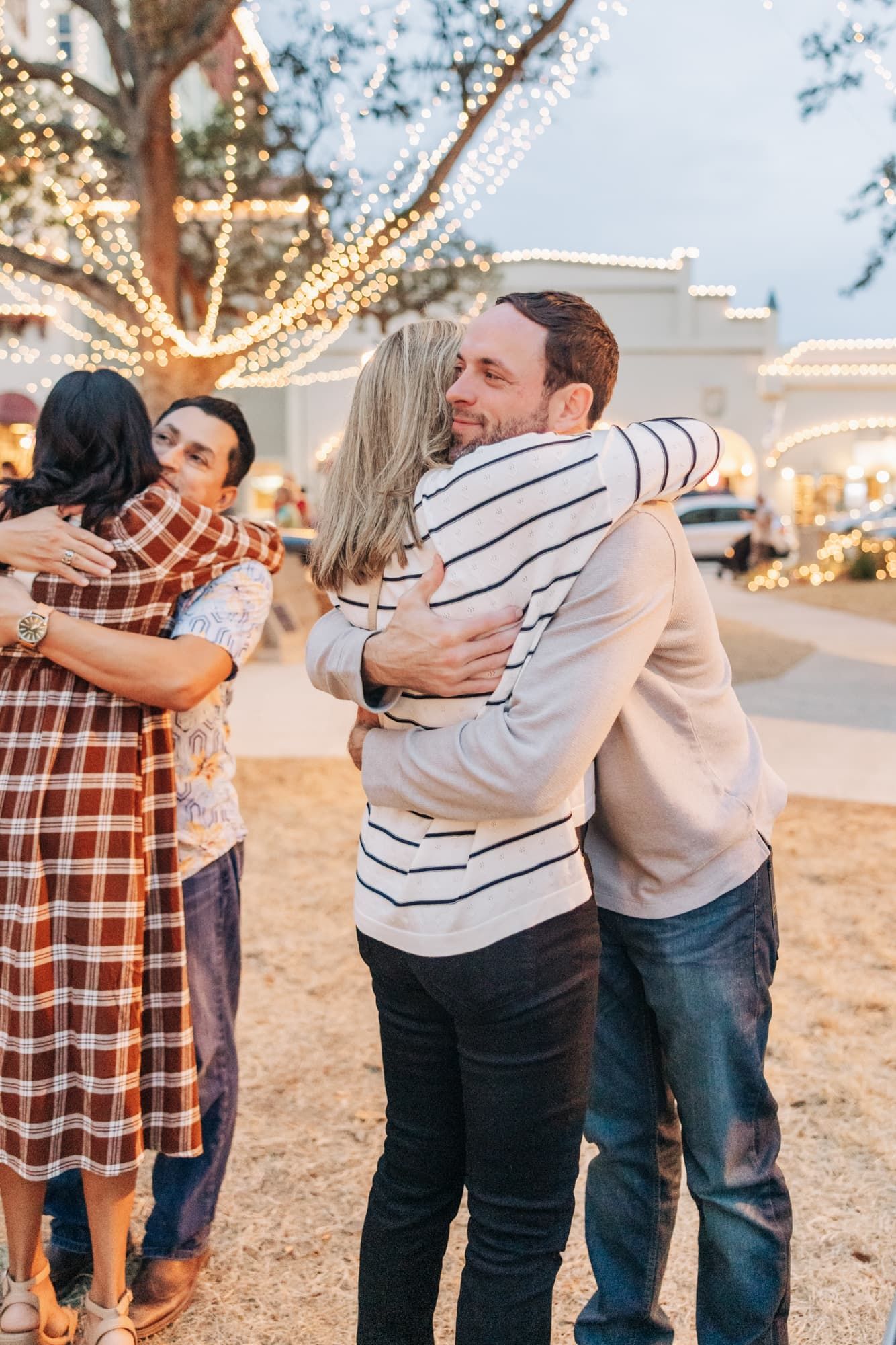 newly engaged couple hugging parents in st Augustine engagement photos