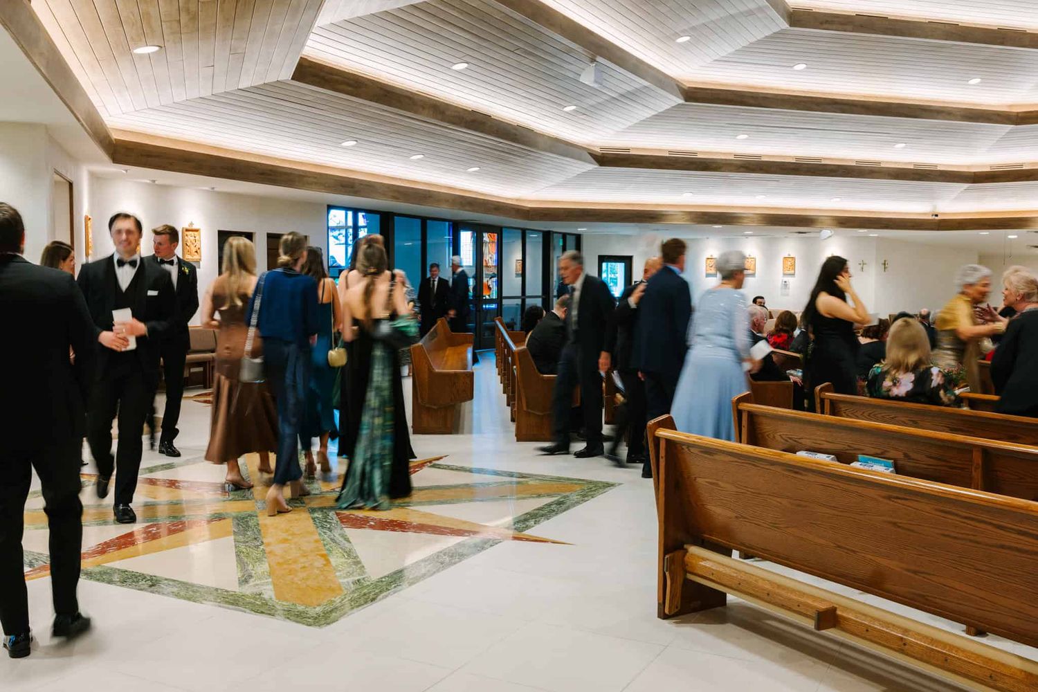 guests walking into wedding in a church
