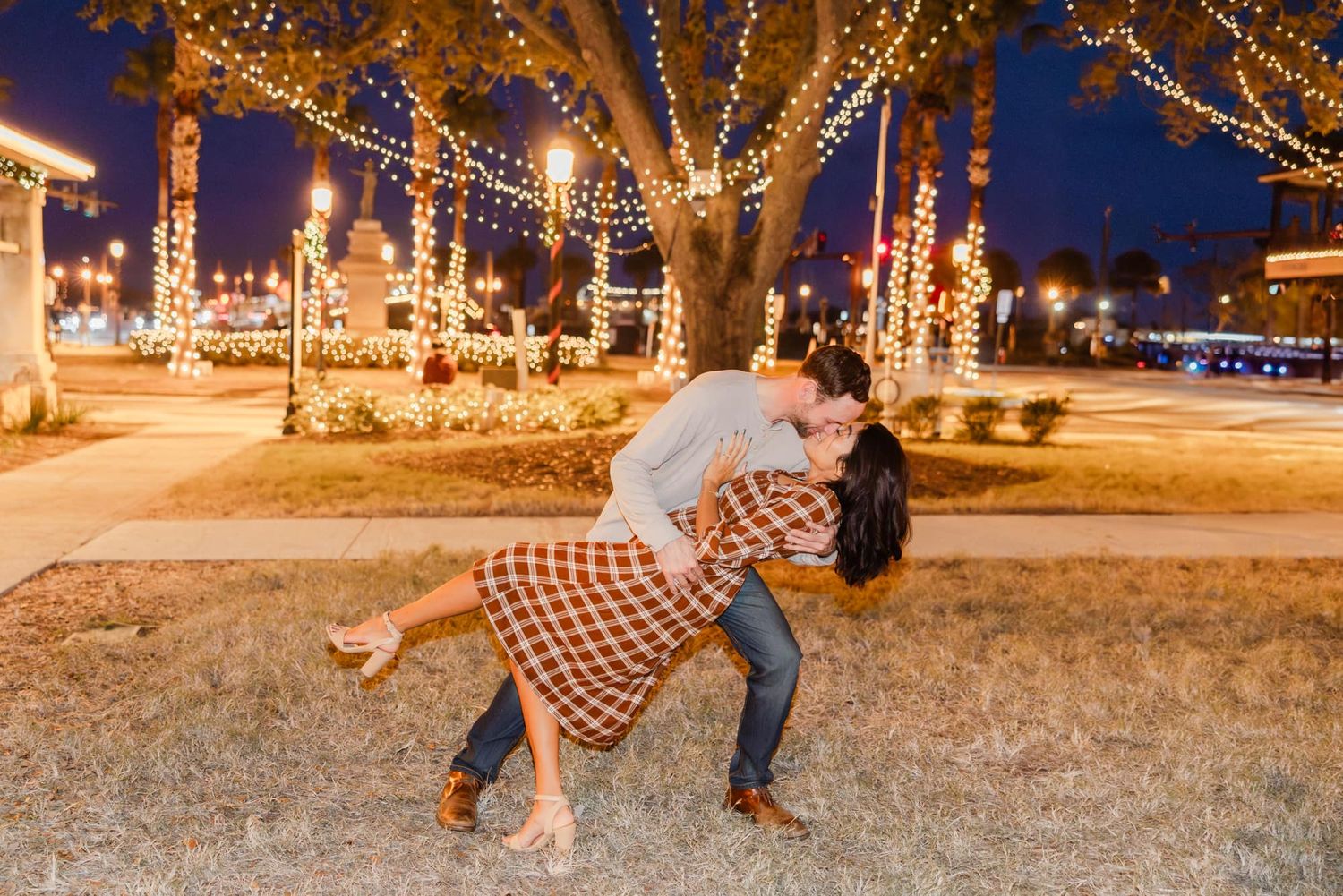 man dipping woman during engagement photos st augustine night of lights