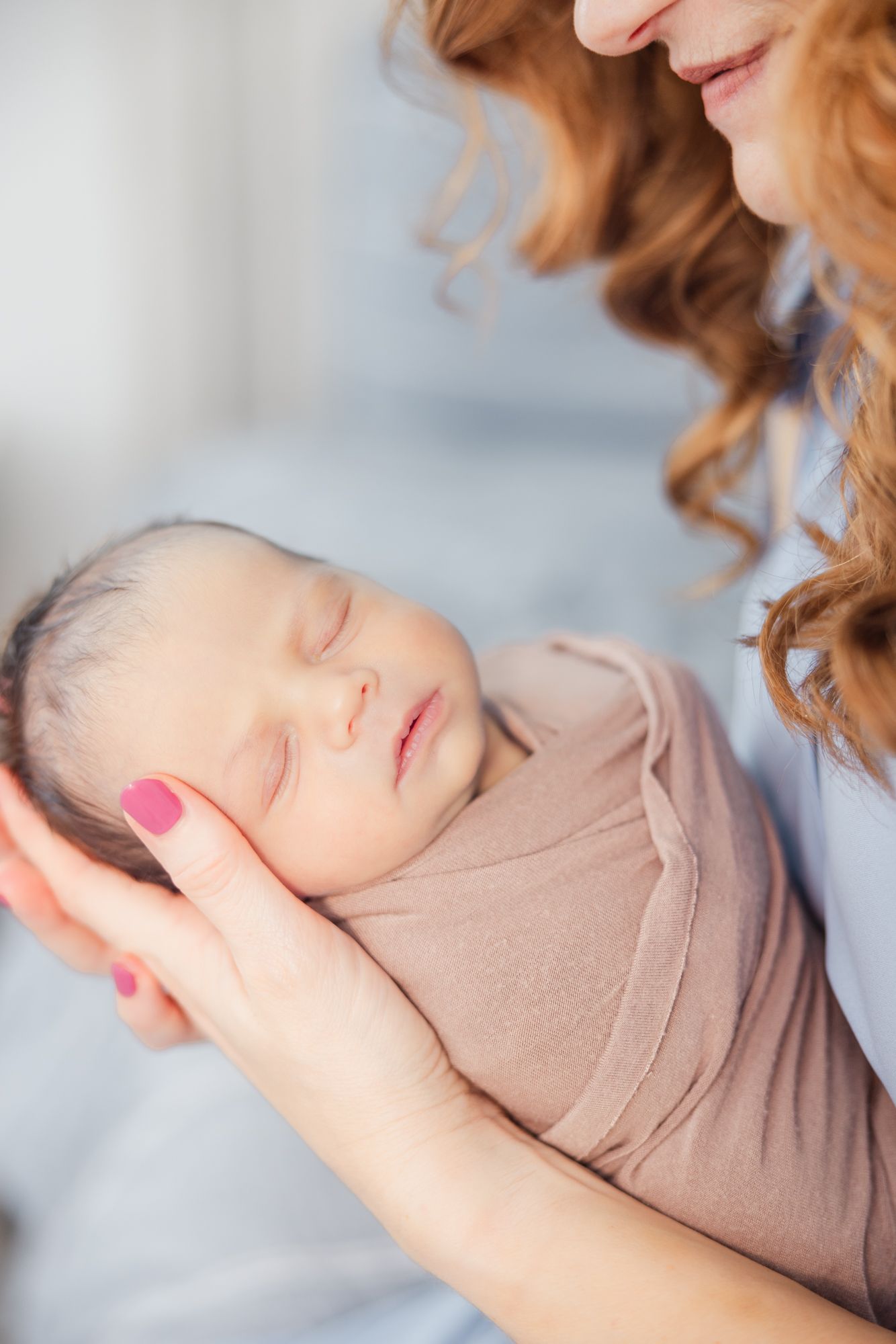 newborn baby in moms arms