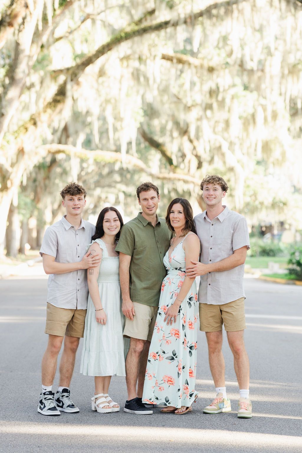family of 5 in the street with pretty mossy trees in the background
