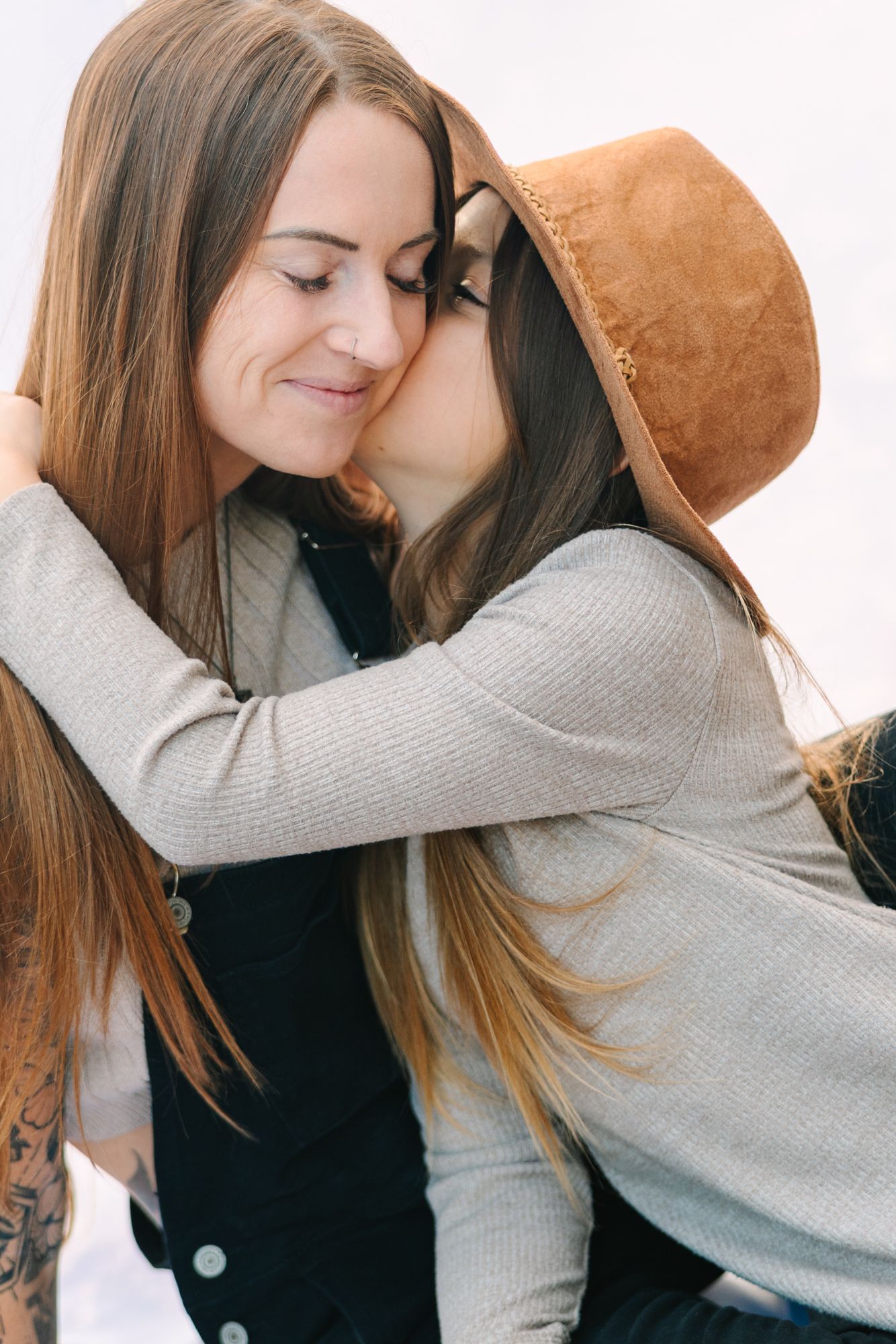 daughter kissing mom on the cheek