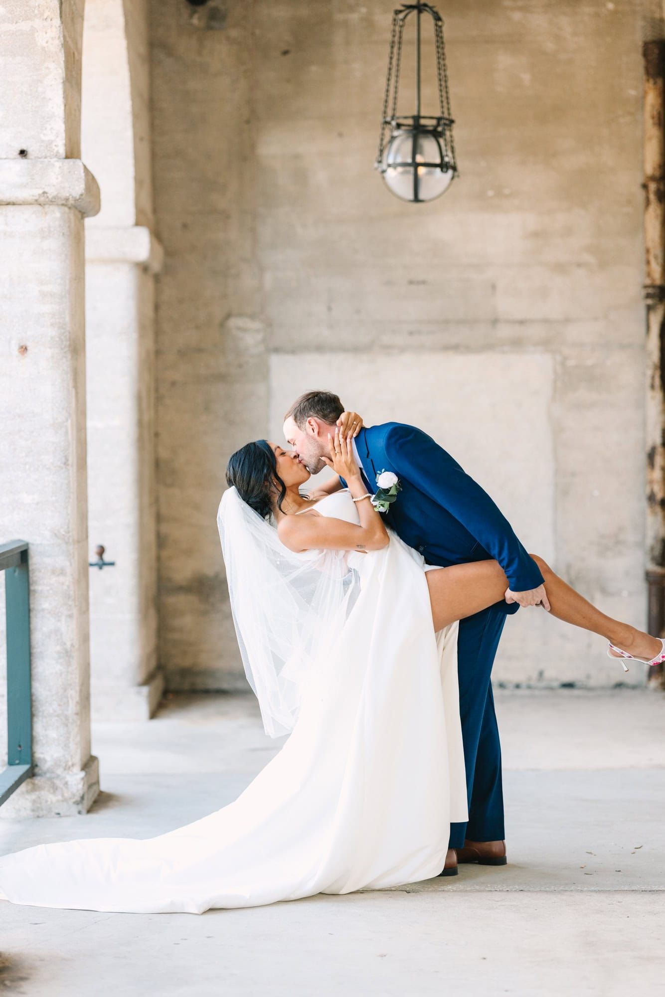 groom dipping bride for a kiss at lightner museum in st augustine