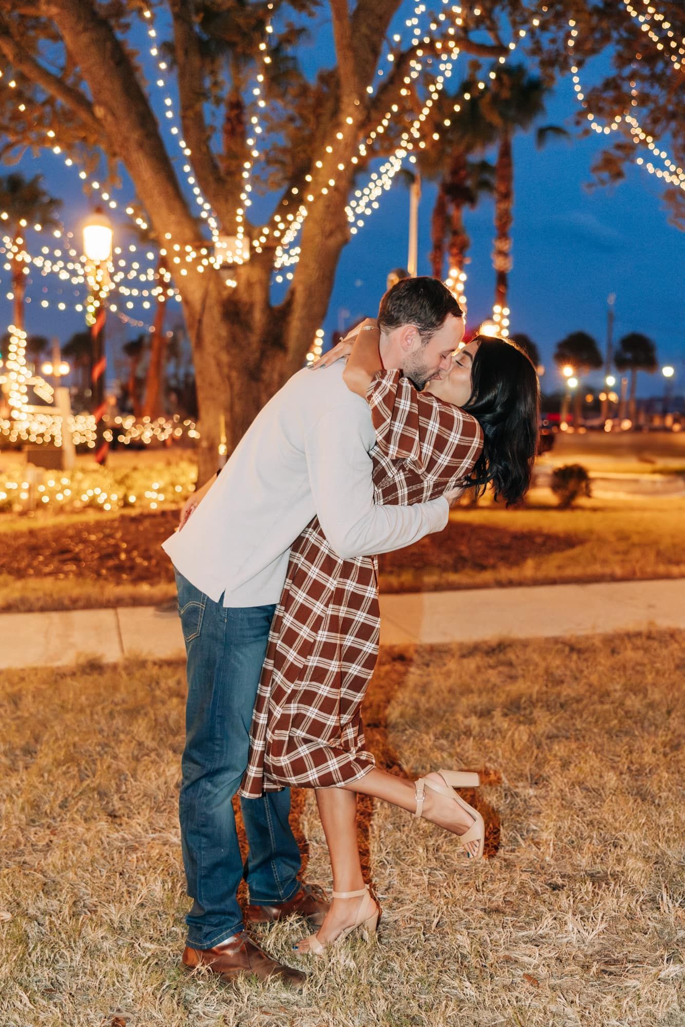 man kissing new fiancé in st Augustine engagement photos during night of lights