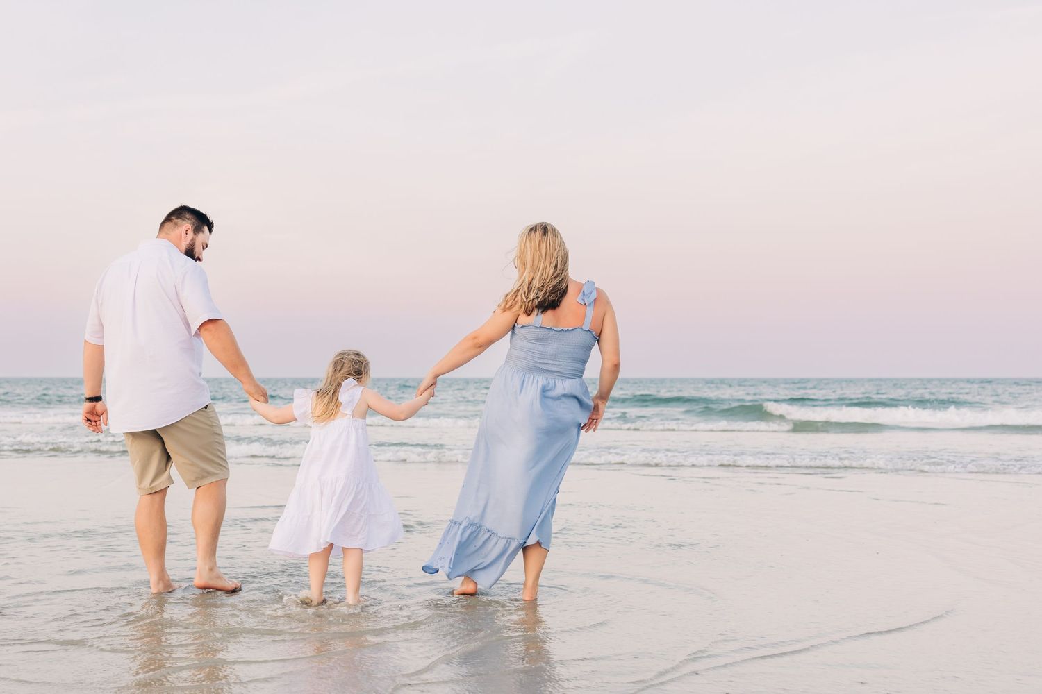 family playing in the water at sunset in Jacksonville Beach fl