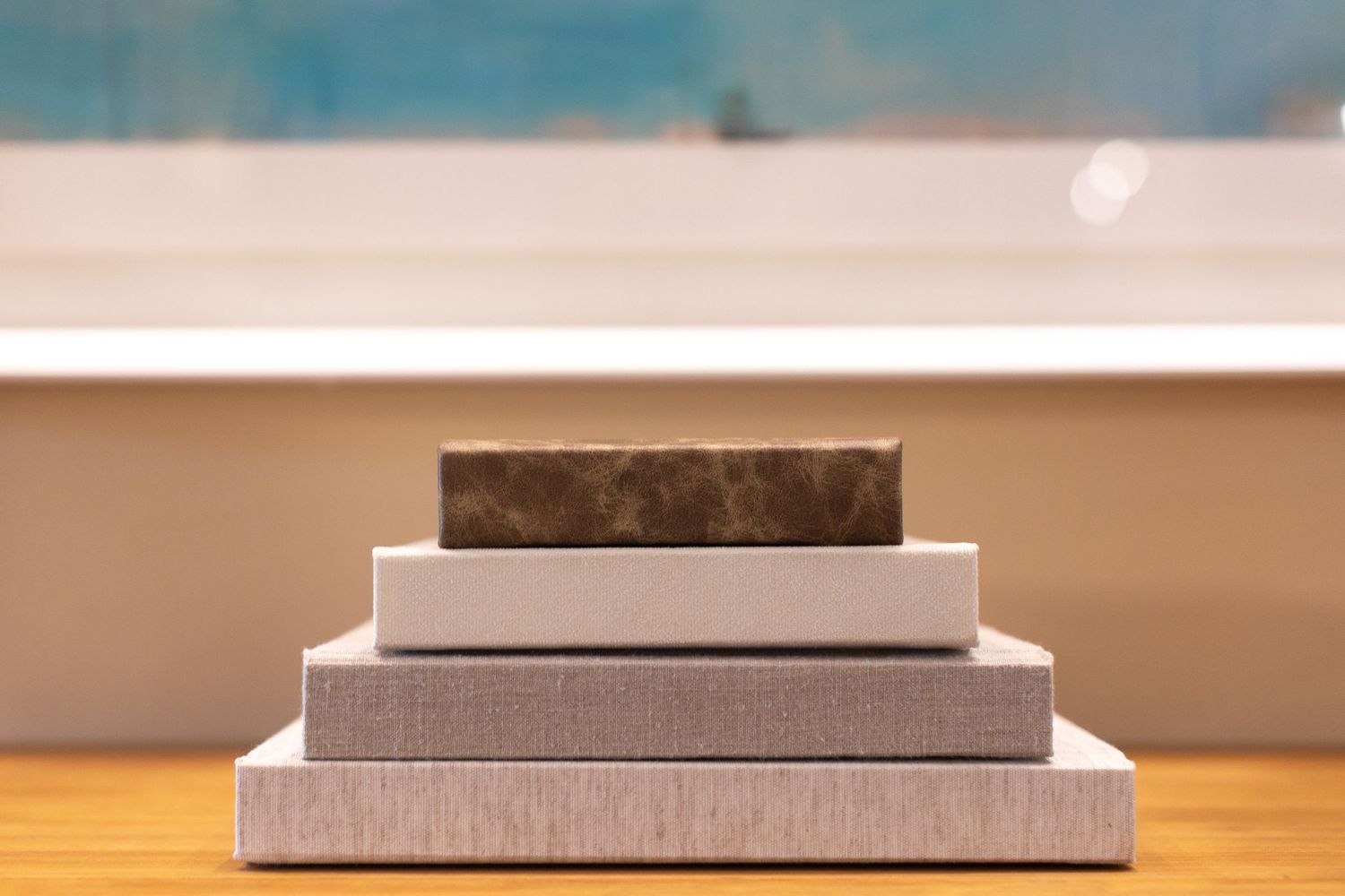 four albums stacked on top of each other by size