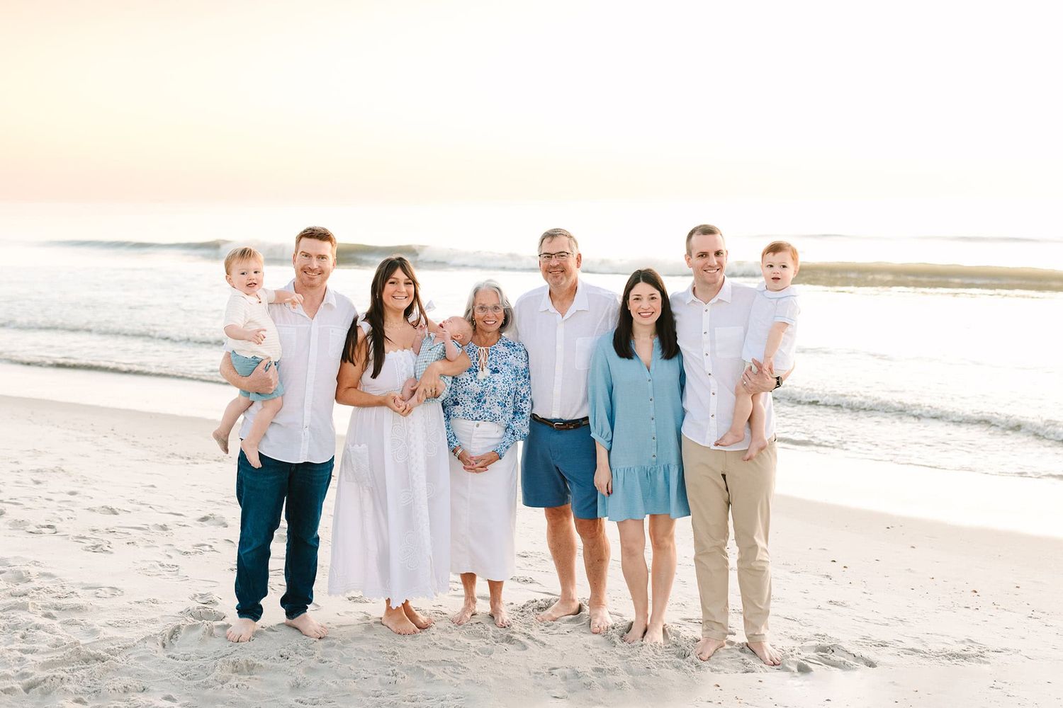 Caitlin Mae on Jacksonville beach at sunrise with her entire extended family