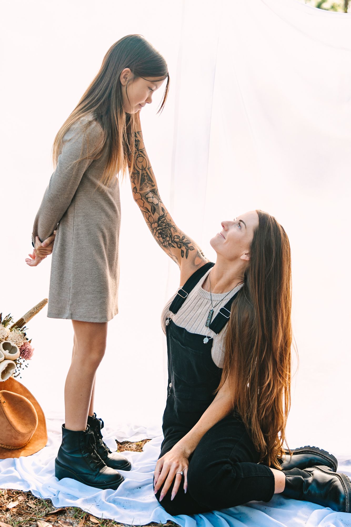mom sitting looking up at her daughter admiring her