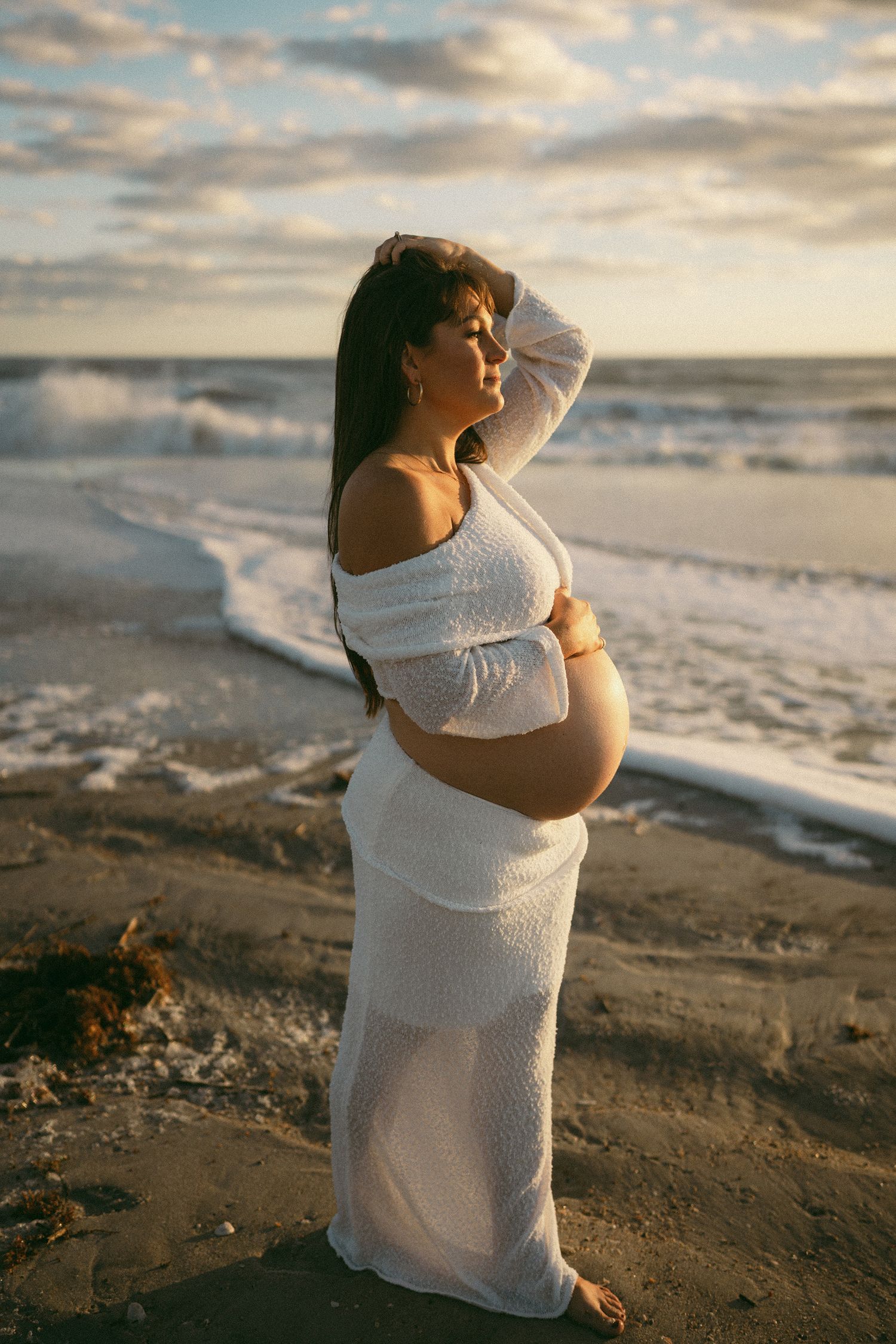 Caitlin pregnant on the beach with her second baby boy