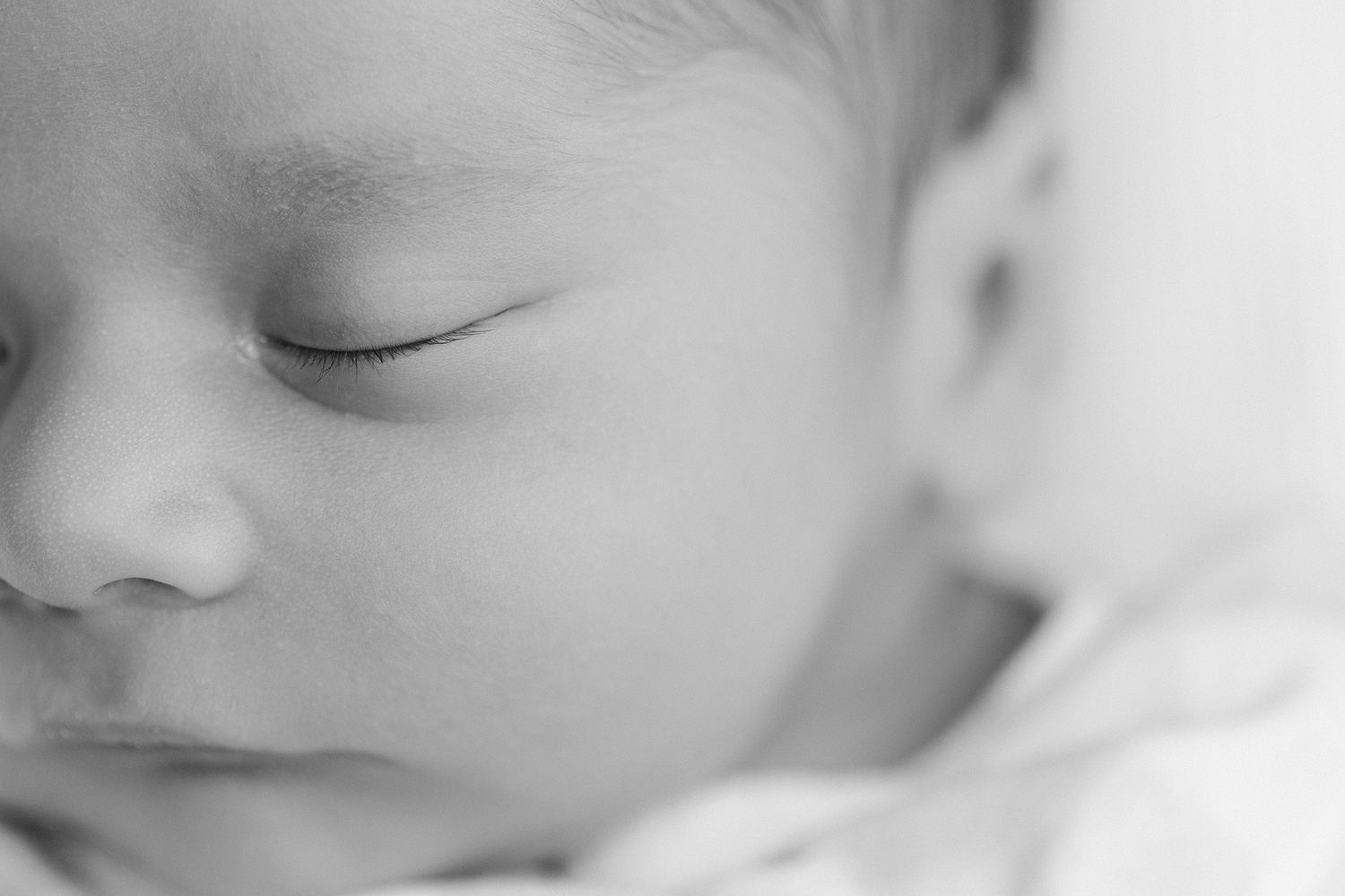 baby face with eyelashes in focus in black and white by Jacksonville, fl photographer