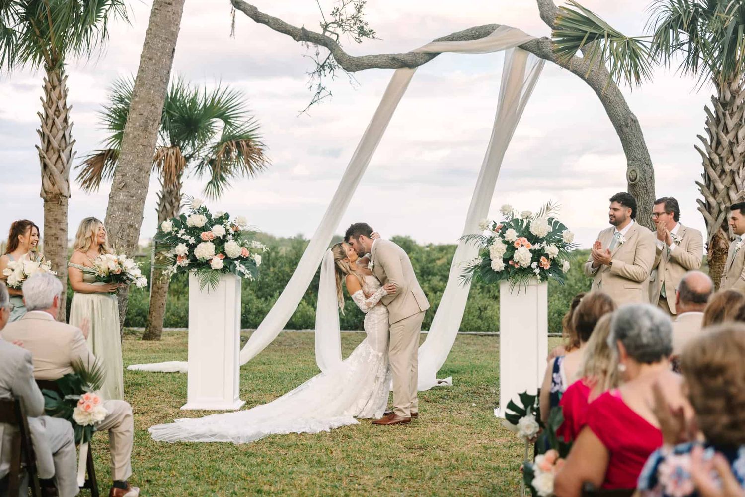 first kiss in front of a tree with drapery