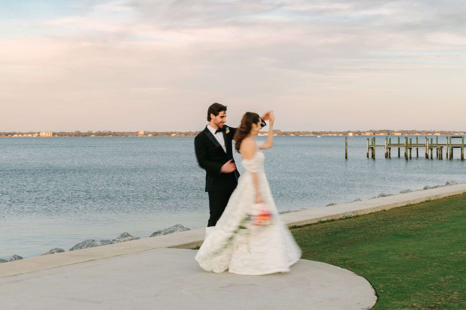 groom twirling bride with motion blur on the river in jacksonville, fl
