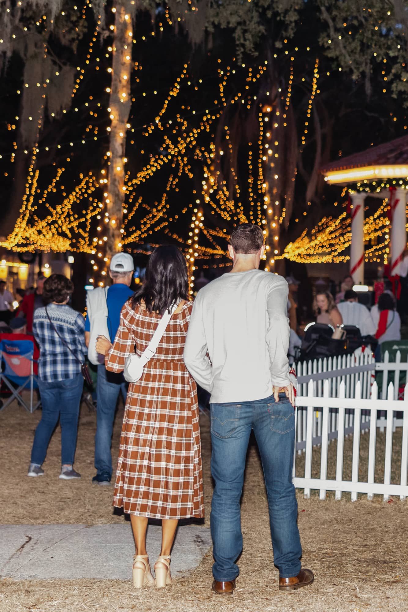 man getting ready to propose pulling ring out of back pocket at night of lights in st Augustine proposal