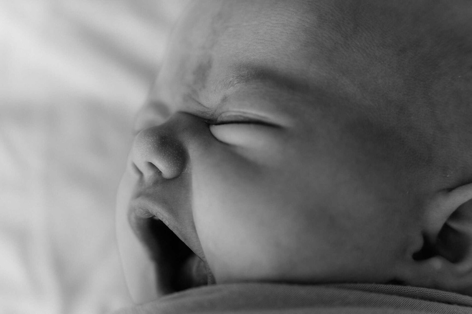black and white close up of newborn yawn