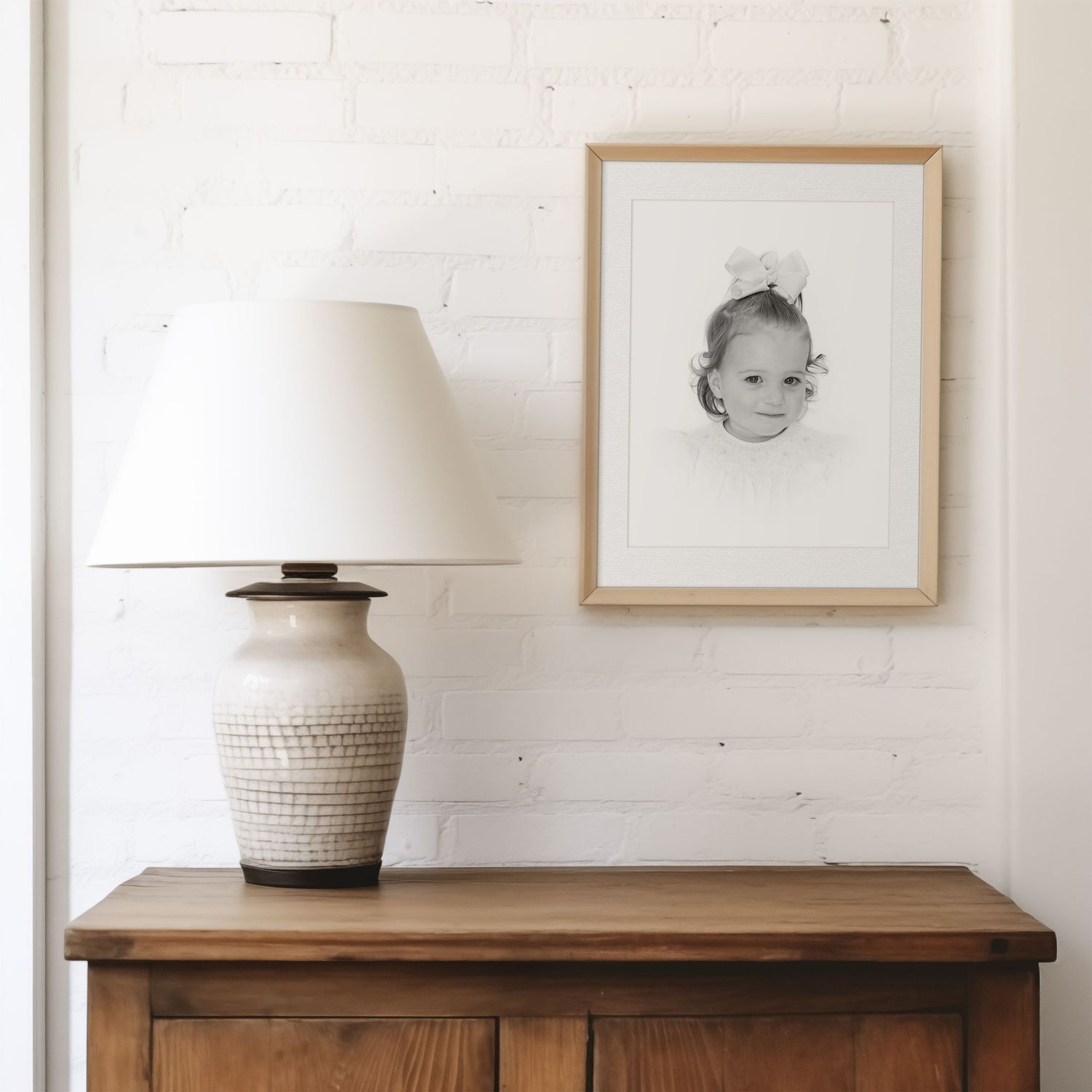 heirloom portrait framed on brick wall