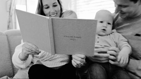 short black and white video of family opening and looking through an album by Jacksonville fl photographer