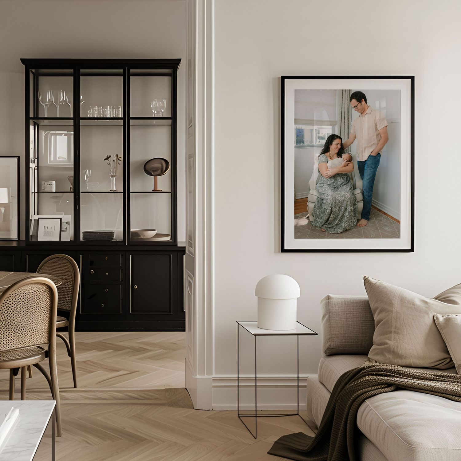 framed artwork of family holding newborn baby