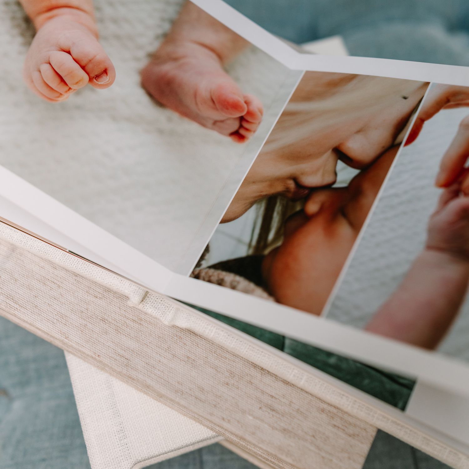 an heirloom album of a jacksonville mom with her newborn baby, open displaying printed newborn baby photos with soft natural lighting.