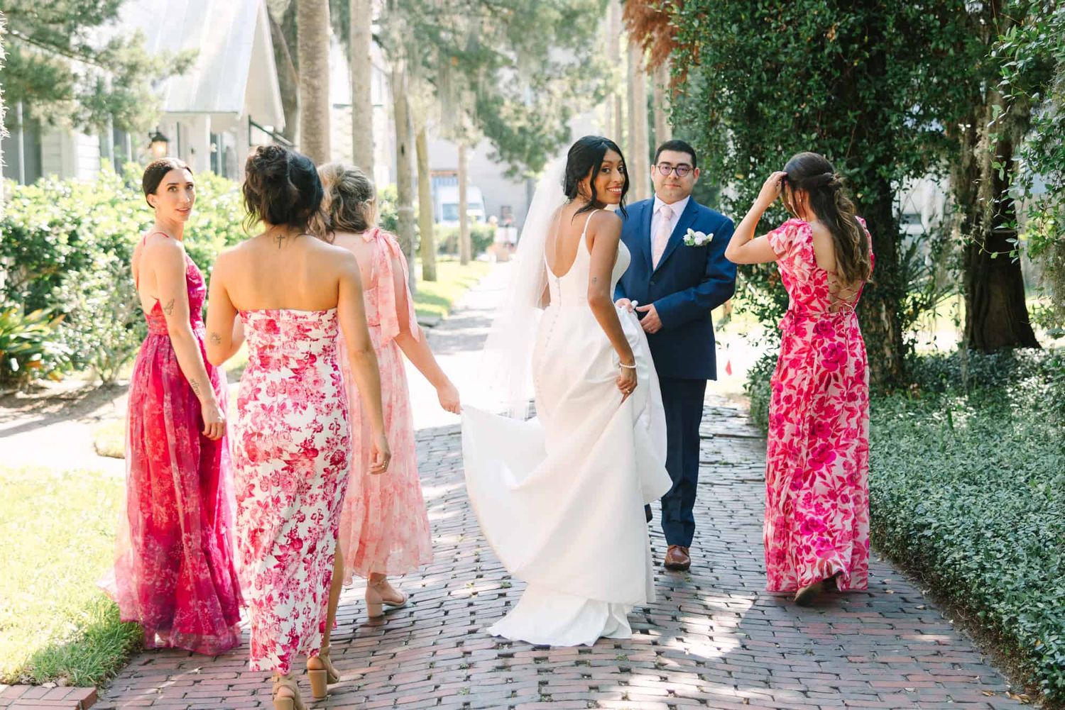 bride and her bridal party walking away as she looks back
