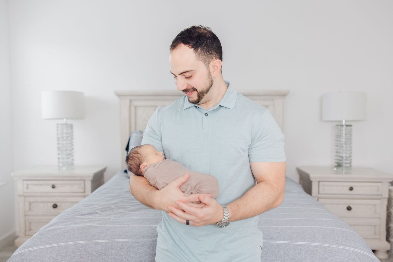 dad holding newborn baby by Jacksonville fl photographer