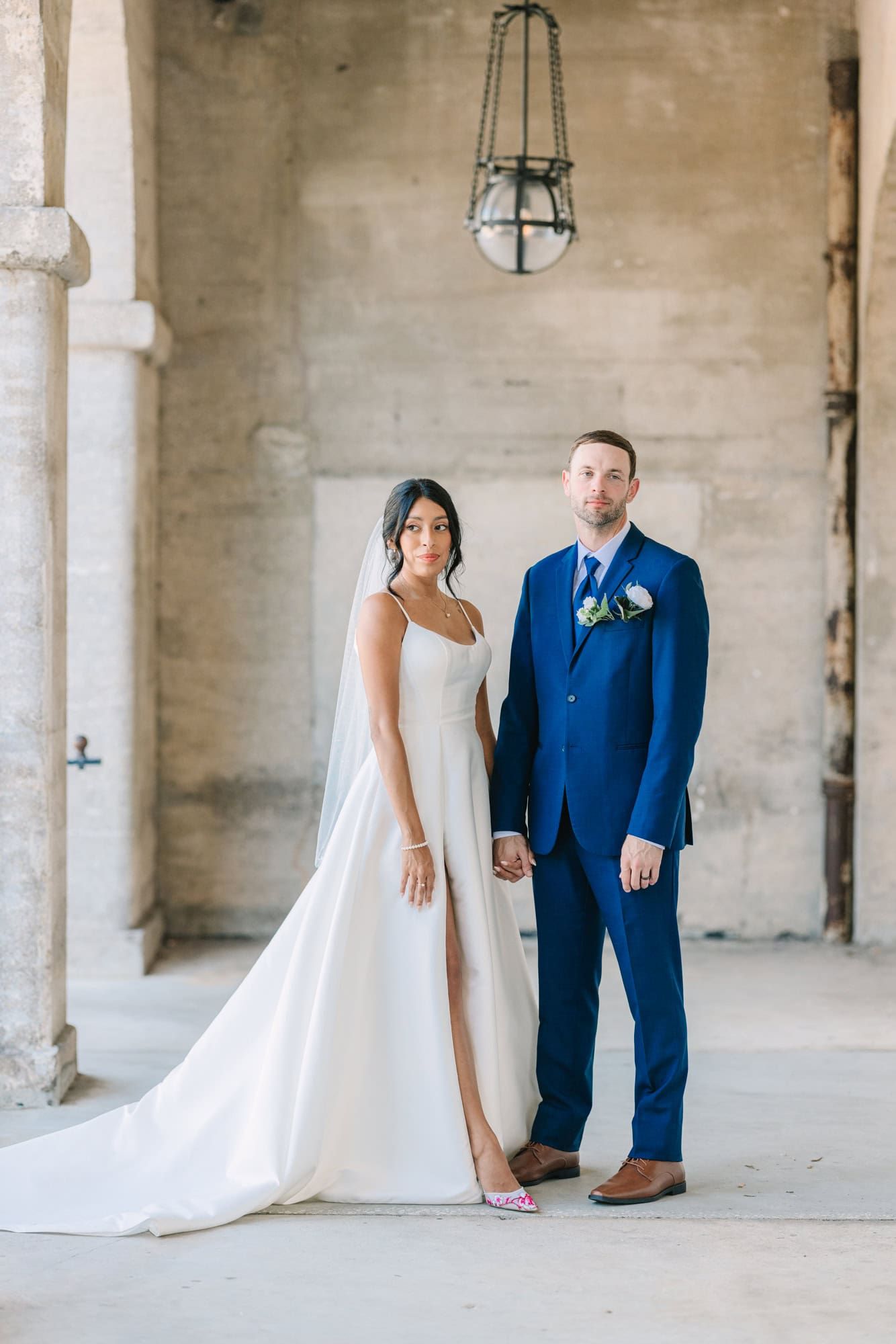 bride and groom standing hand holding hands at lightner museum