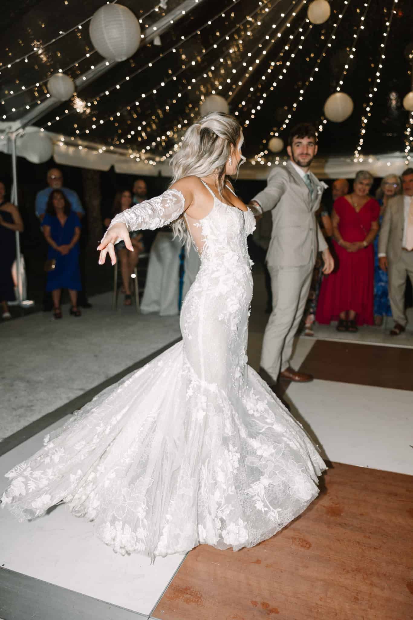 groom twirling bride during first dance