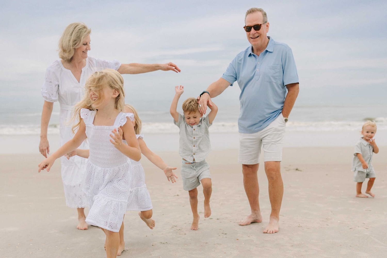grandparents playing with the grandkids. grandkids are running