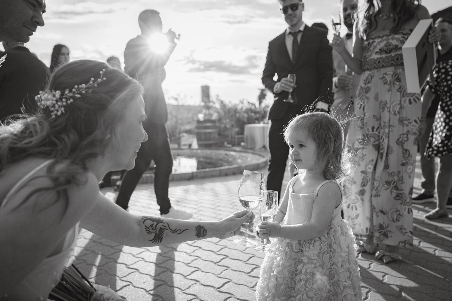 Wedding celebration silhouettes against a bright outdoor setting.