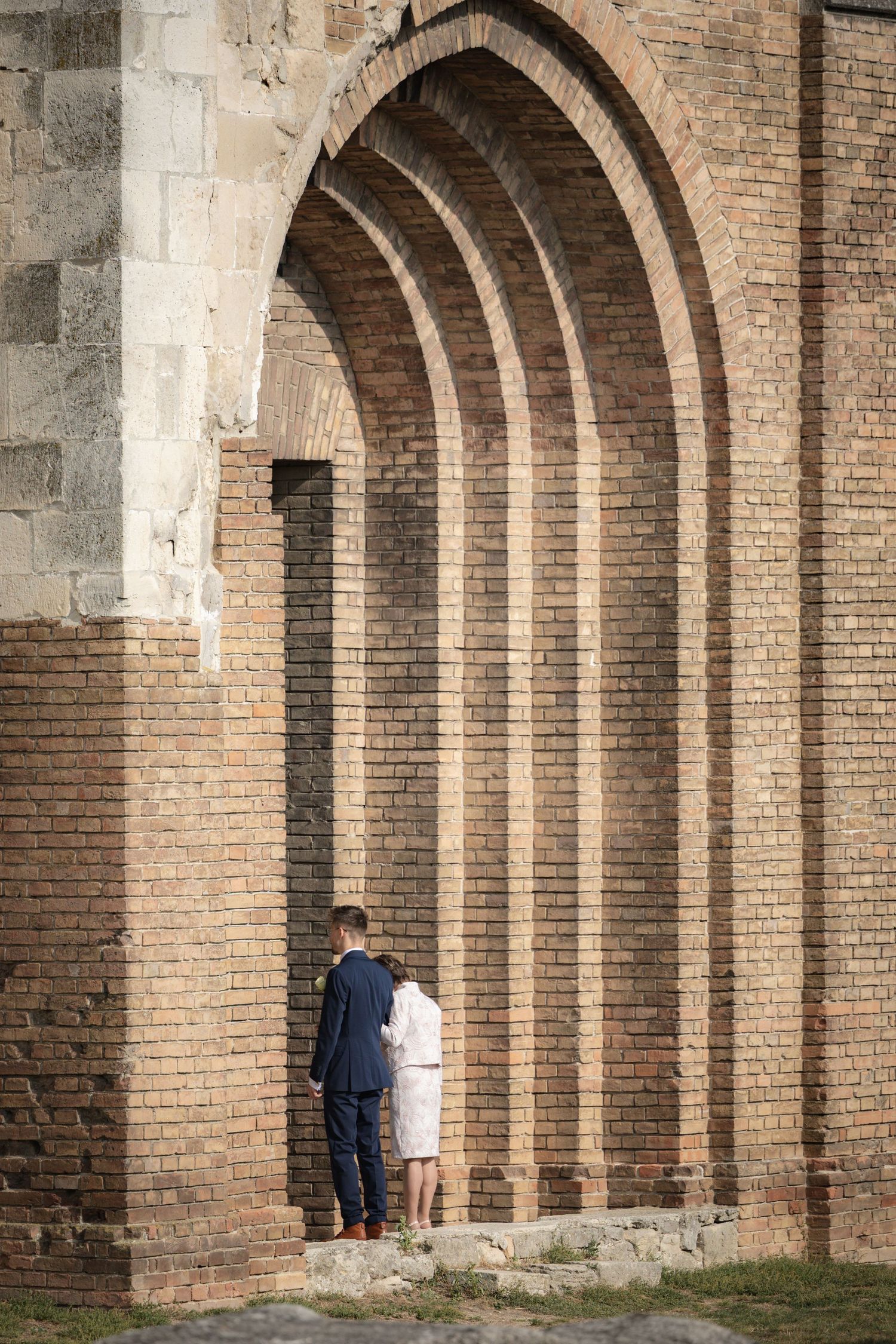 Historic brick archways create a dramatic architectural corridor.