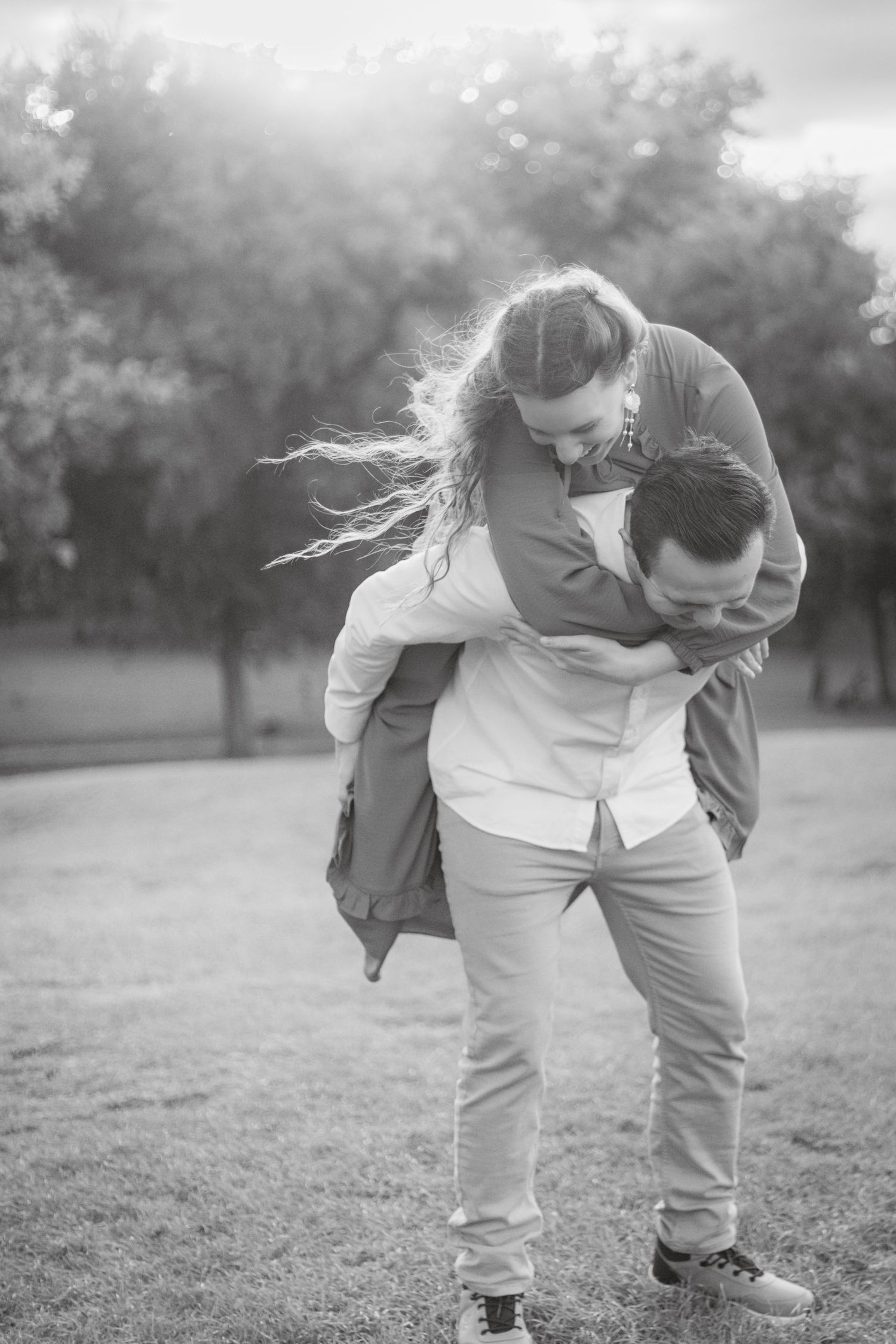 Black and white photo sequence showing playful interaction in a grassy outdoor setting.